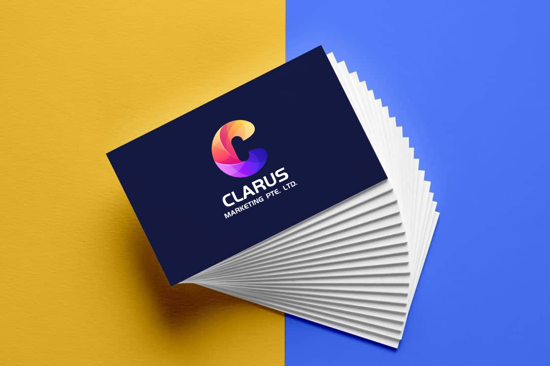 A stack of business cards with a dark blue front displaying the text MEAN PUG. in white and teal, placed on a background split between yellow and blue.