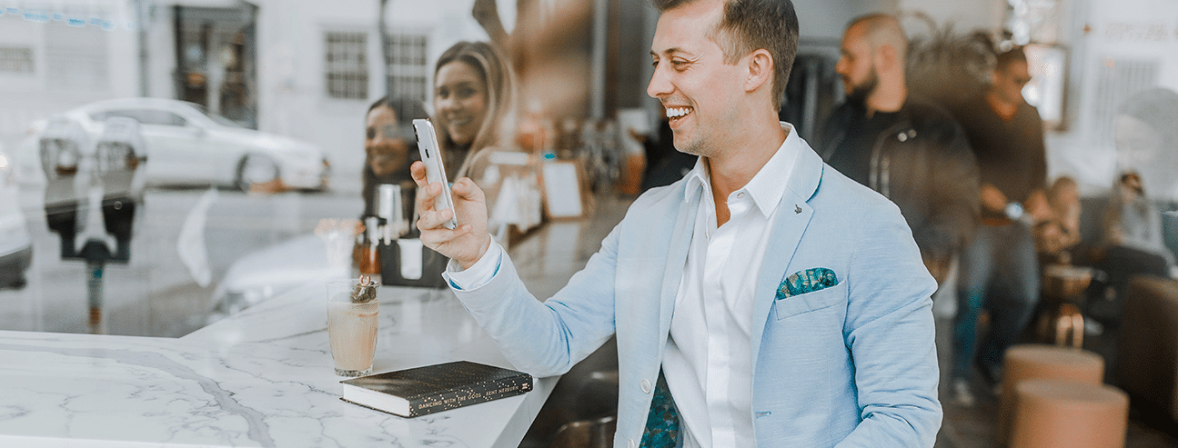 Man looking at client reviews on phone