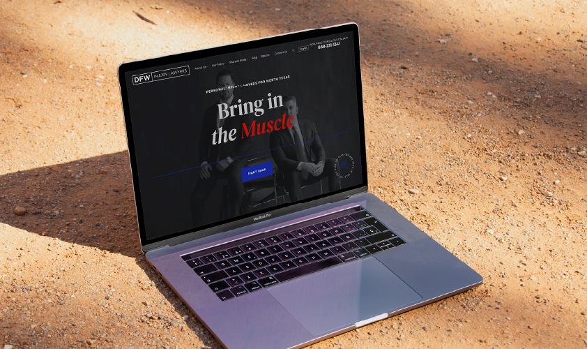 DFW Injury Lawyers website on laptop on ground