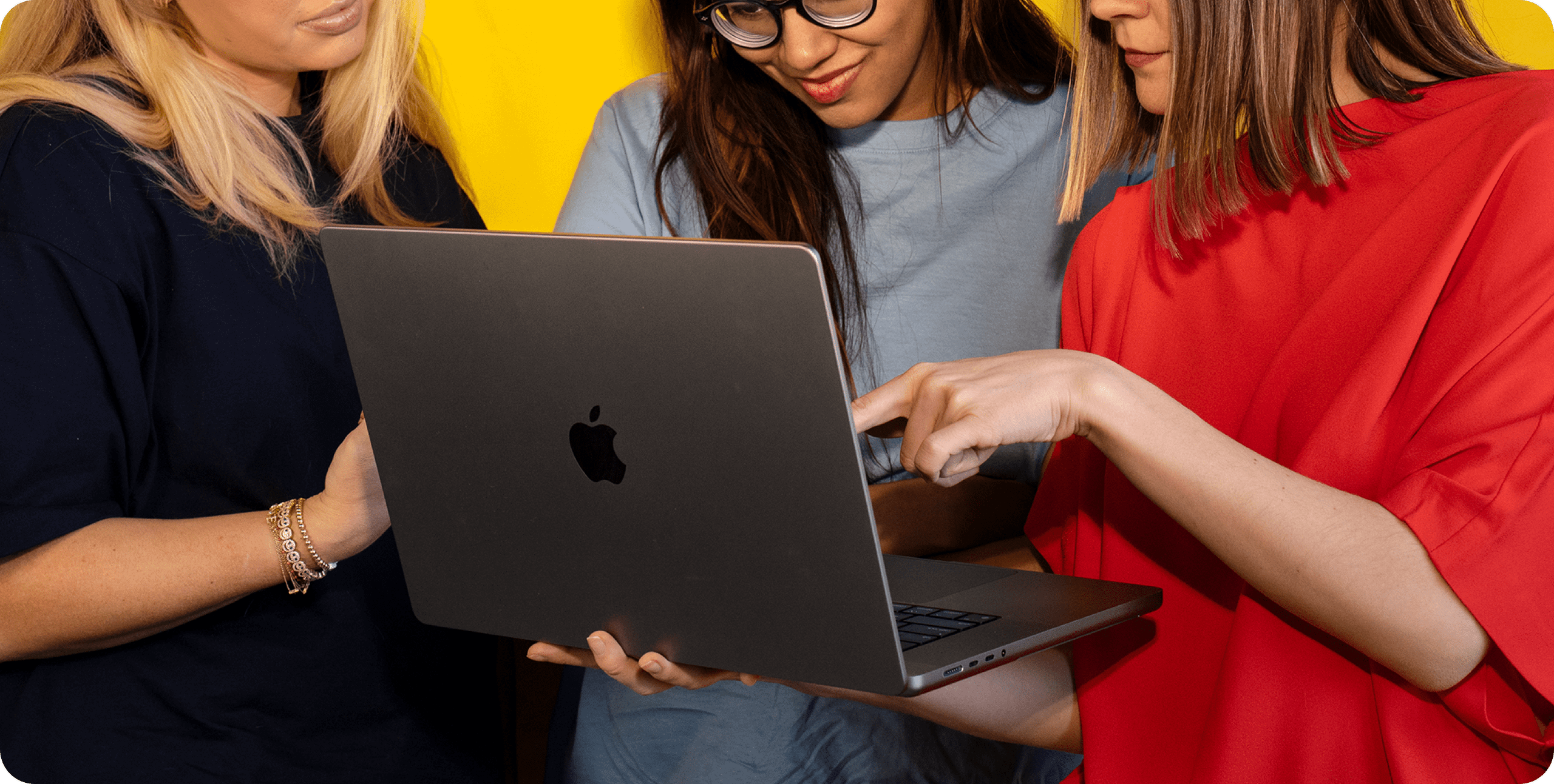 Hope, Ishani, and Oxana around a computer