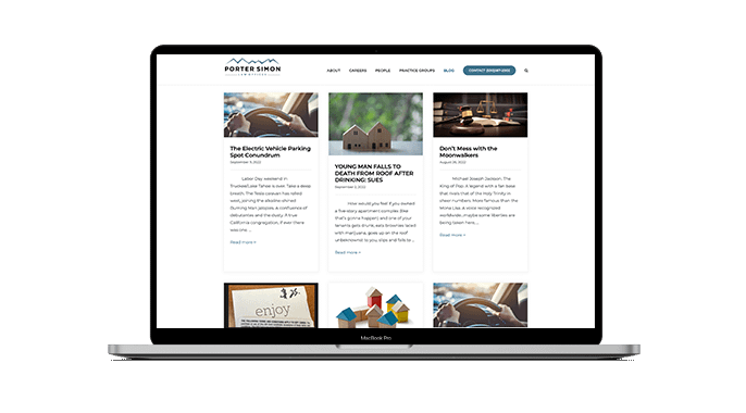 A laptop displays the Porter Simon website’s blog page, showing four articles with images and brief descriptions on legal topics, set against a white background.