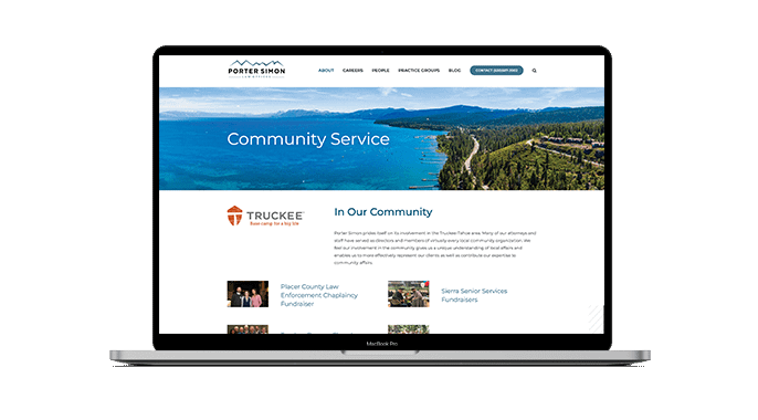 A laptop displays a law firm’s “Community Service” webpage, featuring a lake and forest landscape photo, the Porter Simon logo, and information about local community involvement and partnerships.