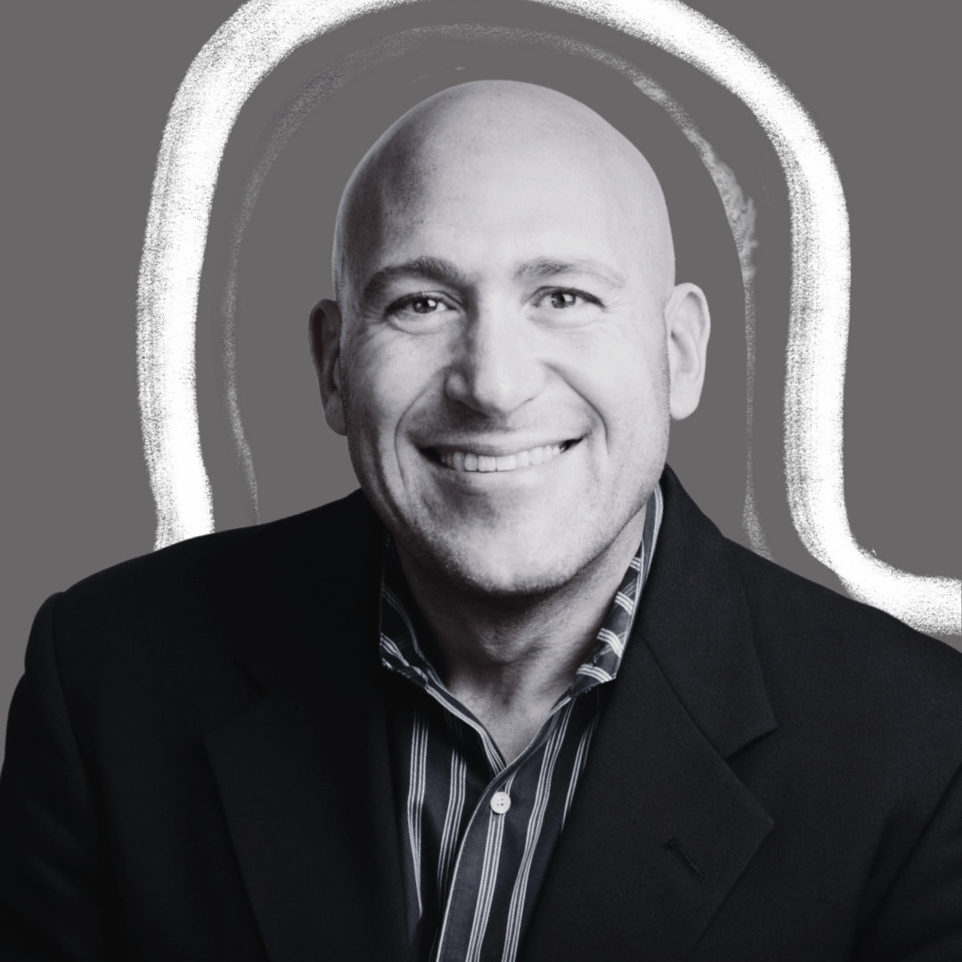 Smiling bald man in a dark blazer and striped shirt, pictured in a black and white portrait with a gray background and a bright, white abstract outline behind him.