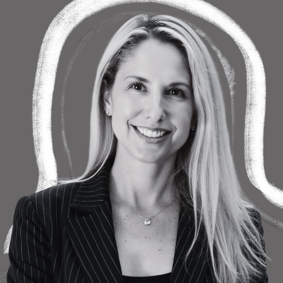 A woman with long blonde hair, wearing a pinstripe blazer and a necklace, smiles at the camera. The background is gray with white abstract lines surrounding her.